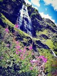 Low angle view of waterfall against sky