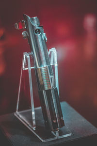 Close-up of machine part on red table