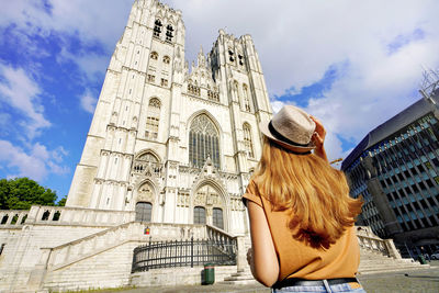 Tourism in brussels. back view of tourist girl visiting brussels cathedral, belgium, europe.