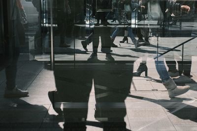 Shadow of people walking on street