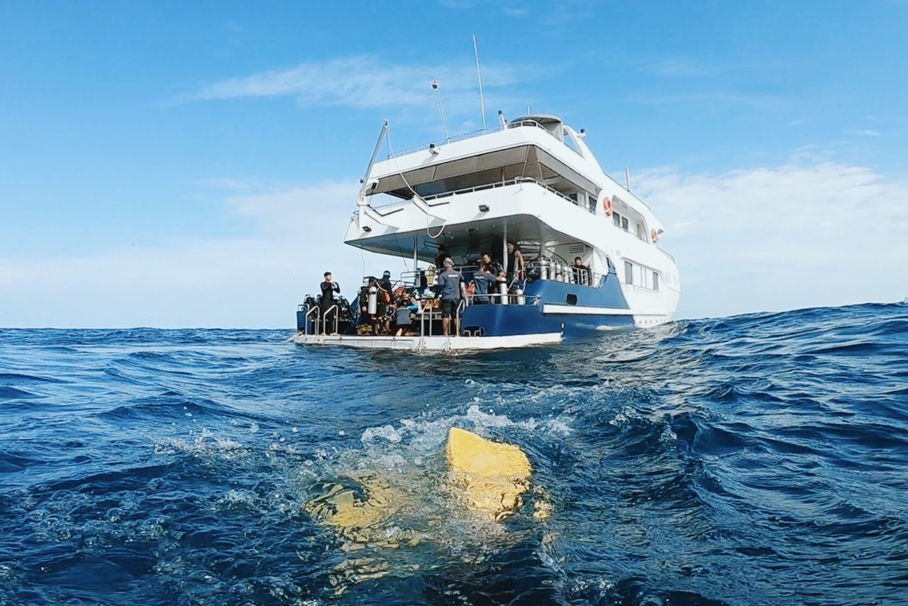 PEOPLE ON BOAT AGAINST SKY