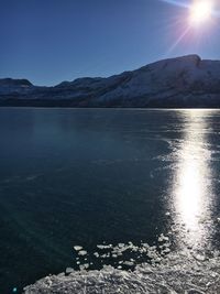 Scenic view of lake against sky during winter