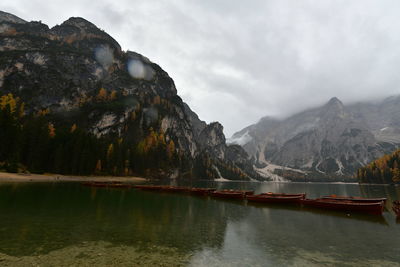 Scenic view of lake by mountains against sky