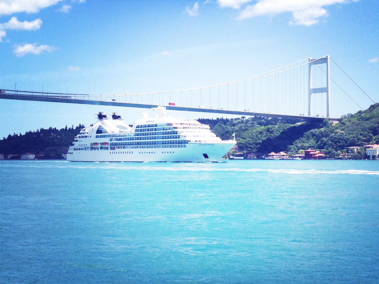 water, sky, transportation, built structure, connection, architecture, waterfront, bridge - man made structure, blue, sea, cloud - sky, nautical vessel, river, suspension bridge, travel, day, nature, travel destinations, engineering, cloud