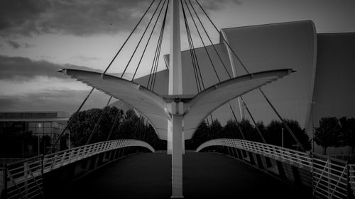 Bridge in city against sky