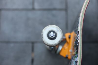 Close-up of skateboard on footpath