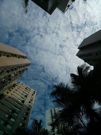 Low angle view of building against cloudy sky