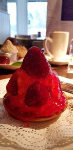 Close-up of red cake in plate on table