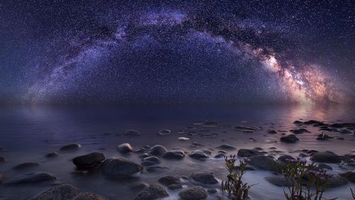 Scenic view of sea against sky at night