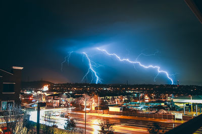 Panoramic shot of illuminated city against sky at night