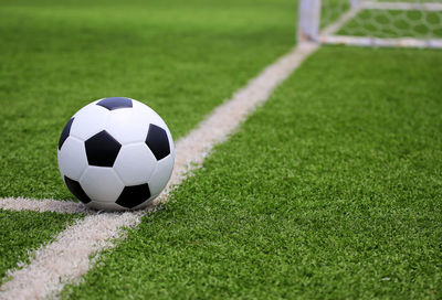 Close-up of soccer ball on field