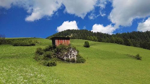 Built structure on field against sky