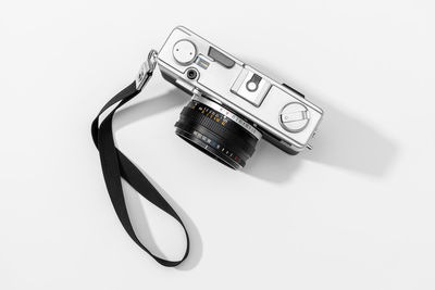 High angle view of camera on table against white background