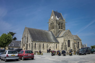 Cars on historic building against sky