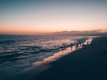 Scenic view of sea against clear sky at sunset