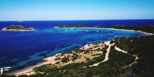 High angle view of bay against clear blue sky, capo coda cavallo, sardinia, italy