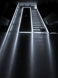 Low angle view of illuminated lighting equipment in building