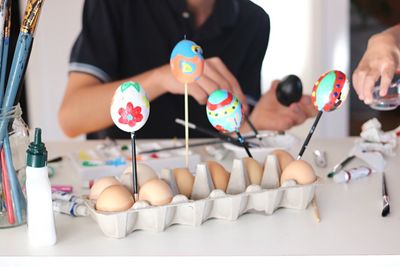 Close-up of people decorating easter eggs