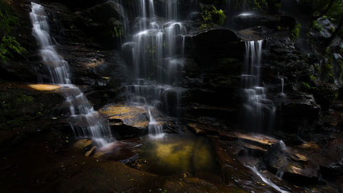 Close-up of waterfall against black background