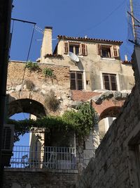 Low angle view of old building against clear blue sky