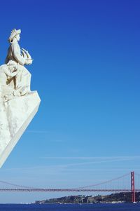 Low angle view of bridge against blue sky