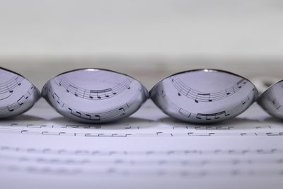 Musical notes reflected in the underside of spoons