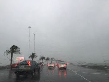 Boats on road against sky