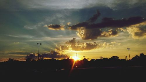 Silhouette trees against sky during sunset