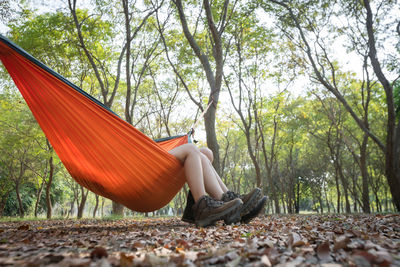 Low section of woman sitting in hammock