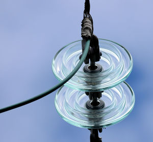 Close-up low angle view of telephone pole against clear blue sky