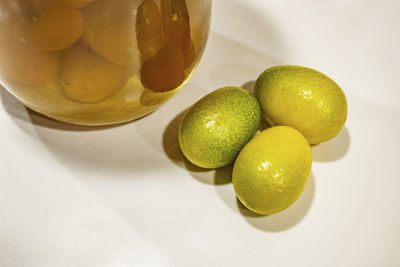 Close up kumquat fruits on white background with kumquat jam