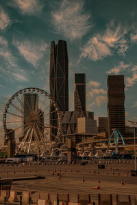 Low angle view of skyscrapers against sky during sunset