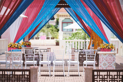 Chairs and tables in restaurant against building