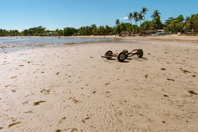 View of shoes on beach against clear sky