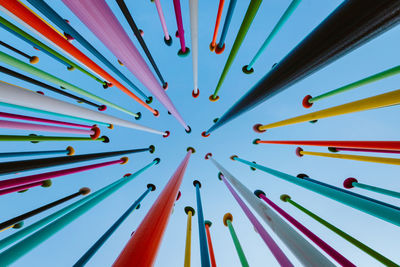 Bottom view of artistic construction made from colored poles in citylife park in milan