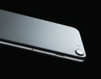 Close-up of smart phone against black background