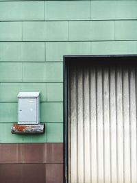 Mailbox mounted on wall by entrance door