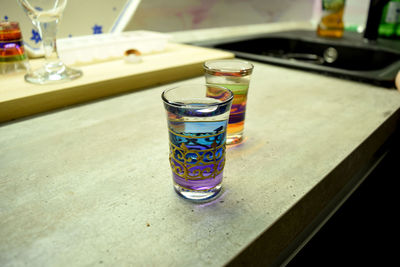 High angle view of vodka in glasses on kitchen counter