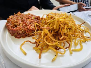 Close-up of food in plate, beef tartar with thin potato curls