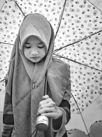 Full length of a young woman sitting outdoors