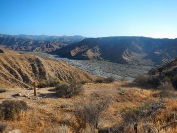 Scenic view of landscape and mountains against clear blue sky