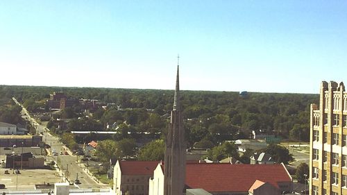 Cityscape against clear blue sky