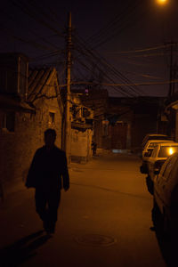 Woman in illuminated city at night