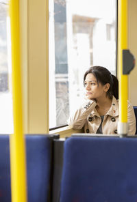 Woman in tram looking through window