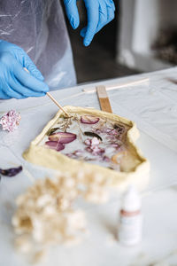 Cropped hand of person preparing food