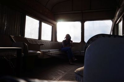 Woman sitting on sofa at home