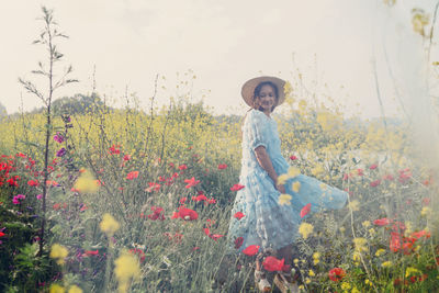 Full length of woman standing on field
