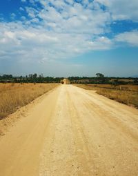 Dirt road along countryside landscape