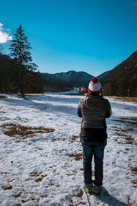 Rear view of man standing in snow
