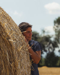 Portrait of woman sitting on hay
